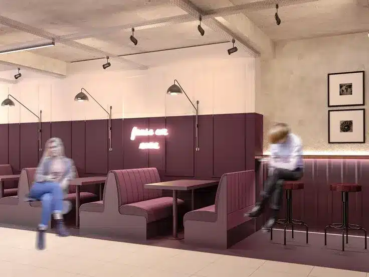 Decoração de pizzaria com estilo moderno e funcional, ideal para um projeto de interiores elegante e atual Inspiração de decoração de pizzarias modernas com iluminação em trilho, mobiliário clean e detalhes em preto e madeira que reforçam o design contemporâneo do ambiente.