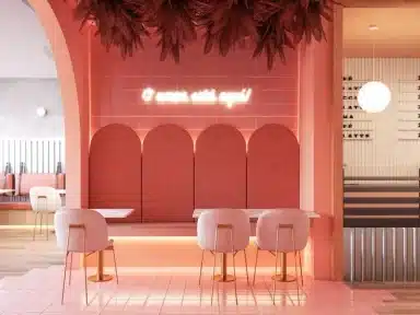 Ambiente de restaurante com projeto comercial moderno em tons de rosa, exemplo inspirador para quem busca como escolher um arquiteto que valorize a experiência sensorial do cliente.