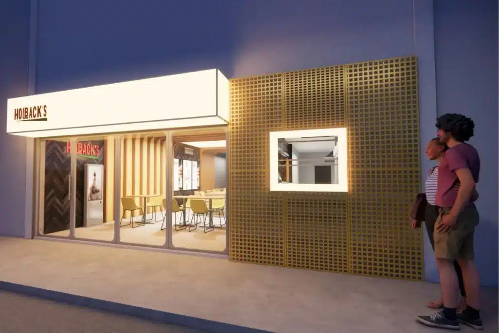 Fachada moderna após reforma em imóvel comercial alugado com estrutura iluminada e ambiente interno acolhedor.