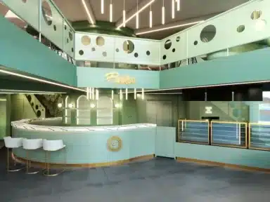 Interior de loja moderna com destaque para tons de verde na parede, incluindo diferentes variações de verde nas divisórias, balcões e detalhes arquitetônicos, criando uma atmosfera contemporânea e convidativa.