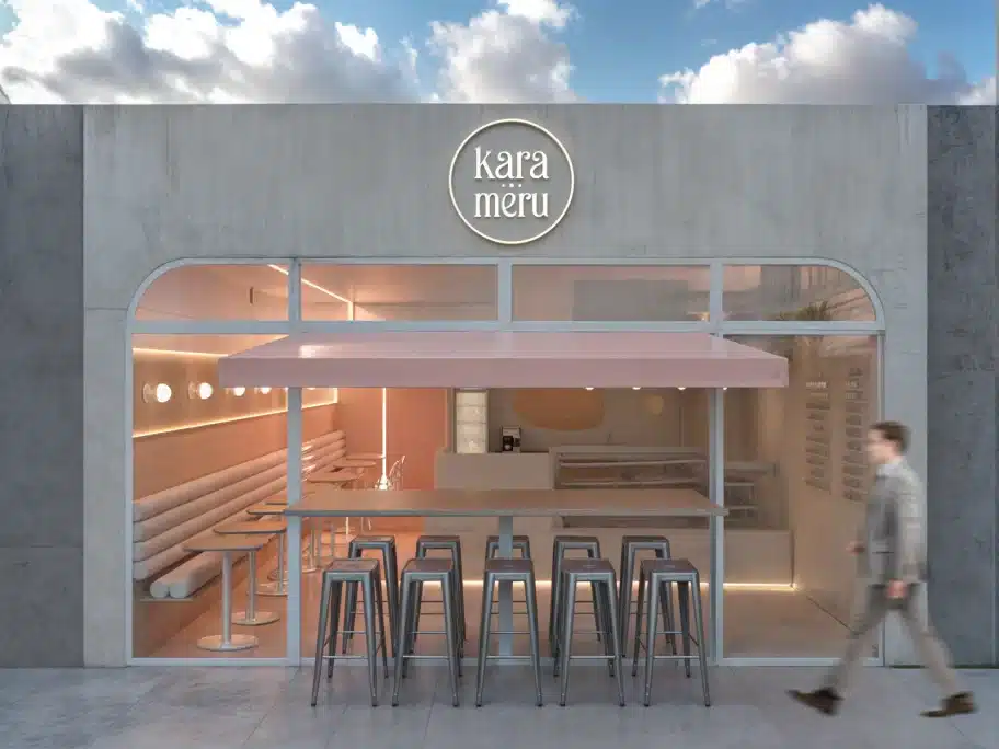 Fachada comercial pequena de cafeteria com design contemporâneo e toldo rosa em destaque.