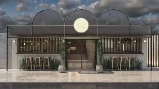 Fachada de cafeteria moderna com elementos em grafite e balcão de atendimento